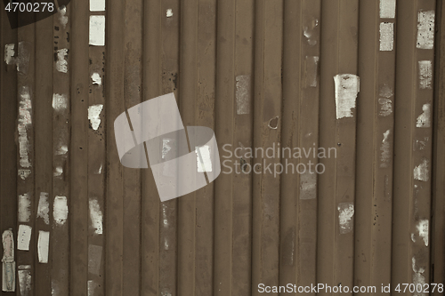 Image of Wooden wall or fence with poster remnants