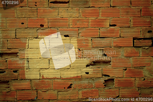 Image of Old damaged wall texture with striated red bricks