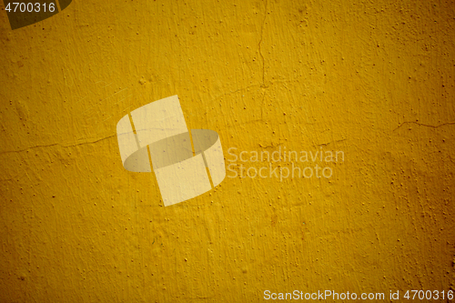 Image of Old grungy ochre colored wall background texture