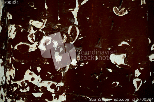 Image of Old wooden panel with grungy peeling dark paint