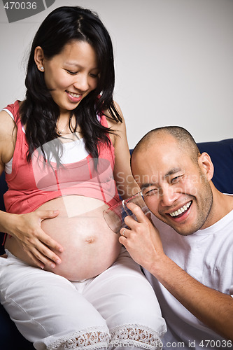 Image of Happy expecting asian parents