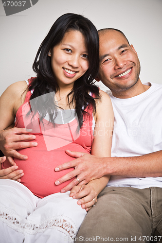 Image of Happy expecting pregnant asian couple