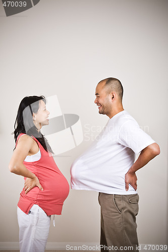 Image of Happy expecting pregnant asian couple