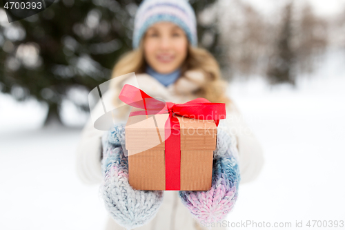 Image of close up of woman with christmas gift in winter