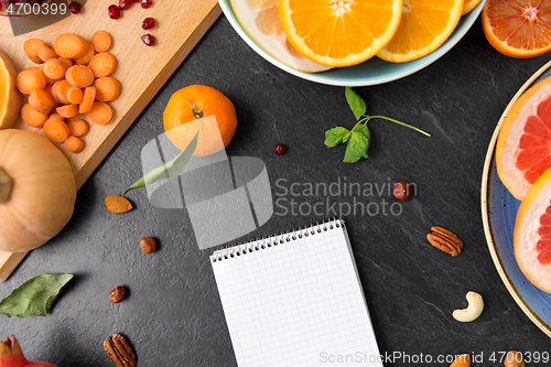 Image of close up of notebook, fruits and vegetables