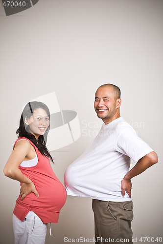 Image of Happy expecting pregnant asian couple