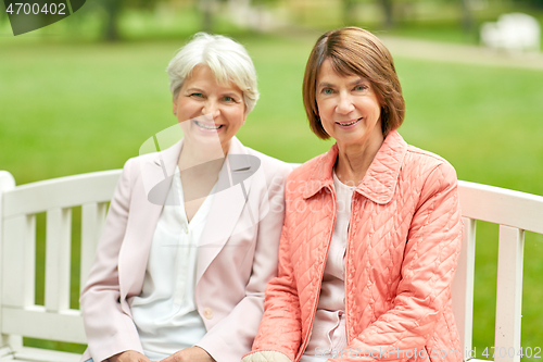 Image of senior women or friends sitting on bench at park