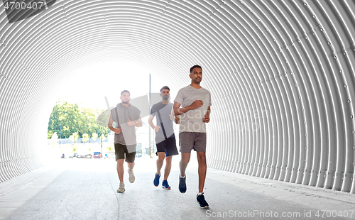 Image of young men or male friends running outdoors