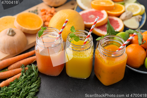 Image of mason jar glasses of vegetable juices on table