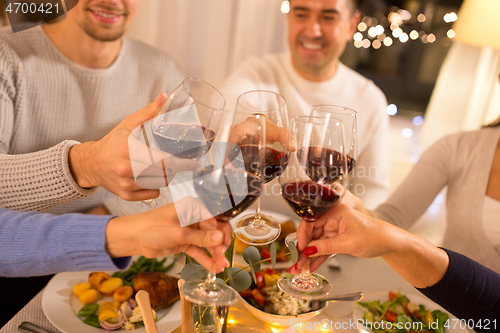 Image of happy family having dinner party at home