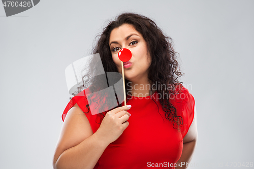 Image of happy woman with red clown nose posing