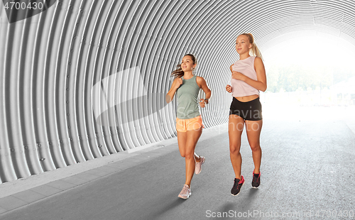 Image of young women or female friends running outdoors