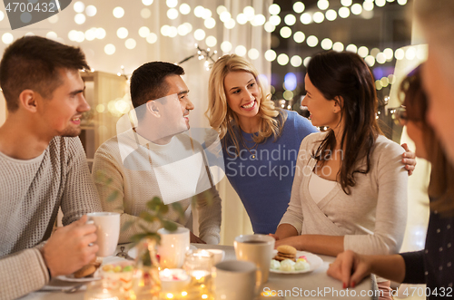 Image of happy family having tea party at home