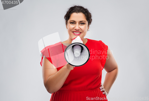 Image of happy woman in red dress speaking to megaphone