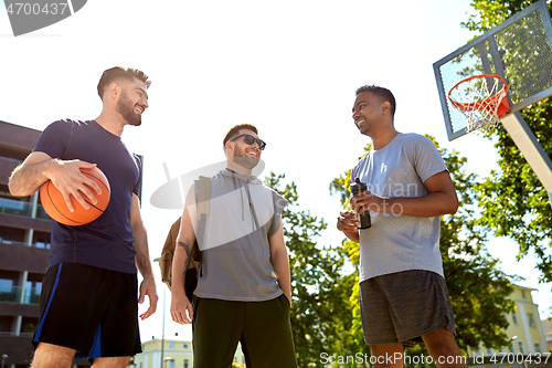 Image of group of male friends going to play basketball