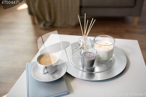 Image of coffee, candles and aroma reed diffuser on table