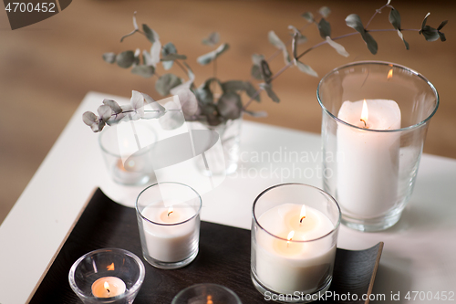 Image of burning fragrance candles on table at cozy home