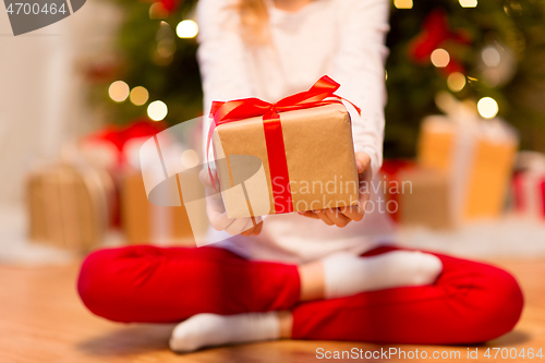 Image of close up of girl with christmas gift at home