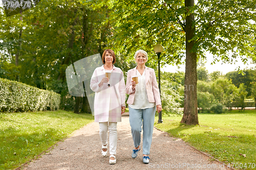 Image of senior women or friends drinking coffee at park