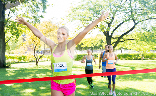 Image of happy young female runner on finish winning race