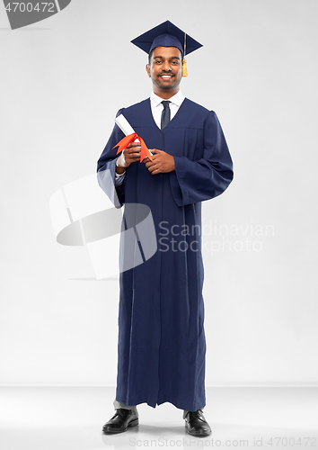 Image of male graduate student in mortar board with diploma