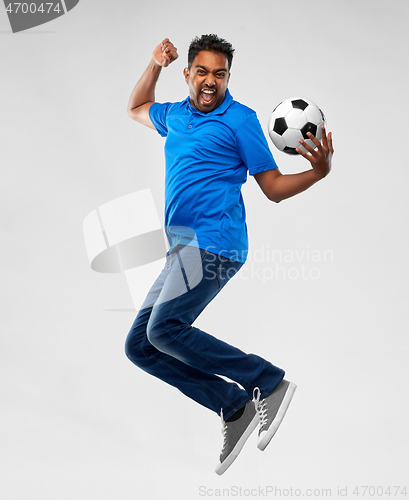 Image of man or football fan with soccer ball jumping