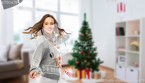 Image of woman dancing at christmas ugly sweater party