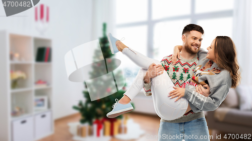 Image of happy couple at christmas ugly sweater party