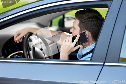 Image of man driving car and calling on smartphone