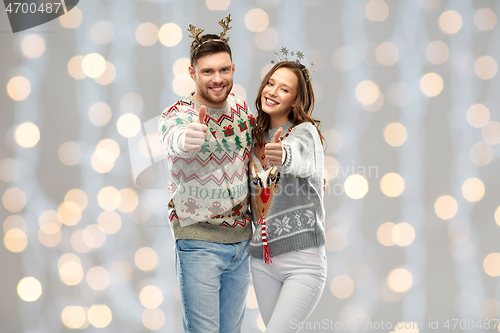 Image of happy couple at christmas ugly sweater party