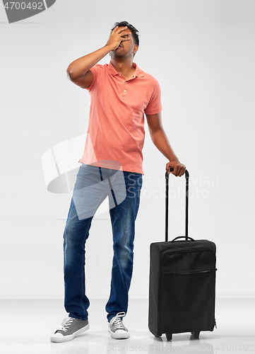 Image of indian man with travel bag making face palm