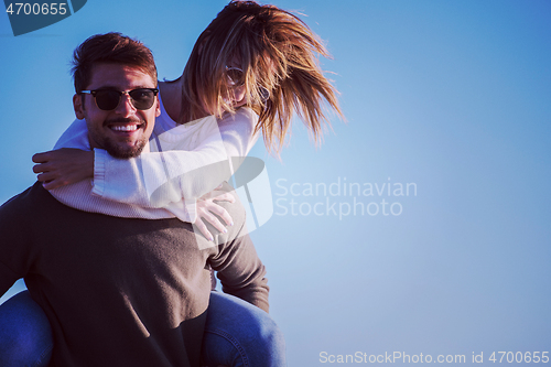 Image of couple having fun at beach during autumn