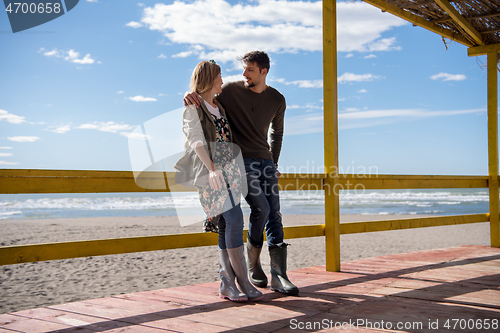 Image of Couple chating and having fun at beach bar