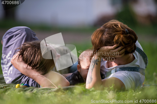 Image of hipster family relaxing in park