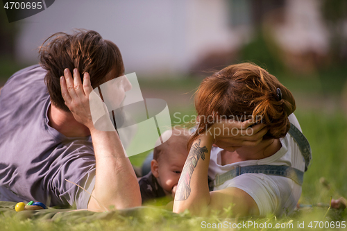 Image of hipster family relaxing in park