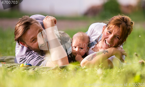 Image of hipster family relaxing in park