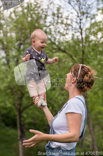 Image of woman with baby  in nature