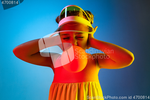 Image of Young girl blowing bubble gum