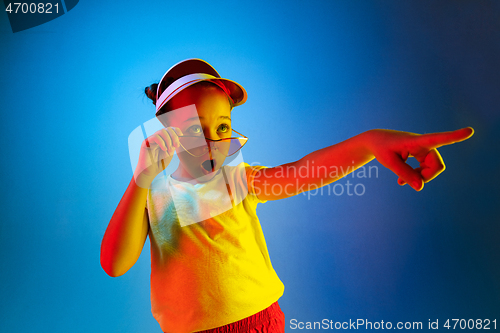 Image of Beautiful teen girl looking suprised isolated on blue