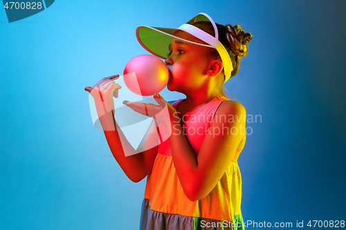 Image of Young girl blowing bubble gum