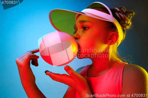 Image of Young girl blowing bubble gum