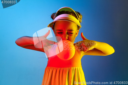 Image of Young girl blowing bubble gum