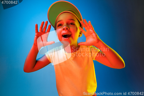 Image of Beautiful teen girl looking suprised isolated on blue