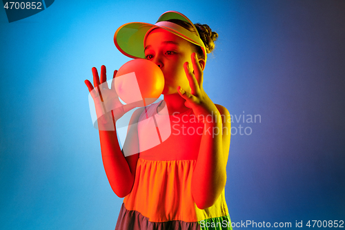 Image of Young girl blowing bubble gum