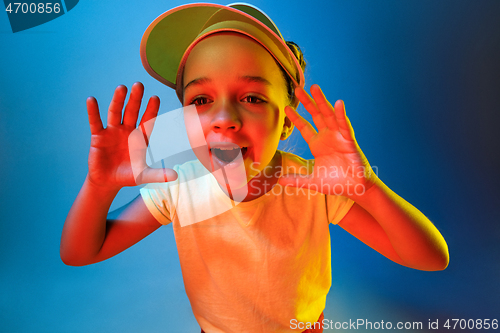 Image of Beautiful teen girl looking suprised isolated on blue