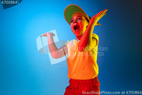 Image of Beautiful teen girl looking suprised isolated on blue