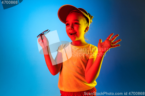 Image of Beautiful teen girl looking suprised isolated on blue