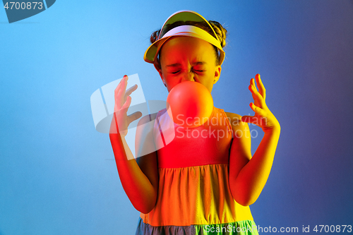 Image of Young girl blowing bubble gum