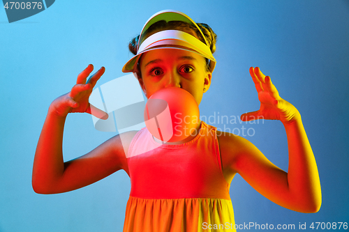 Image of Young girl blowing bubble gum