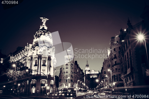 Image of Rays of traffic lights on Gran via street, main shopping street in Madrid at night. Spain, Europe